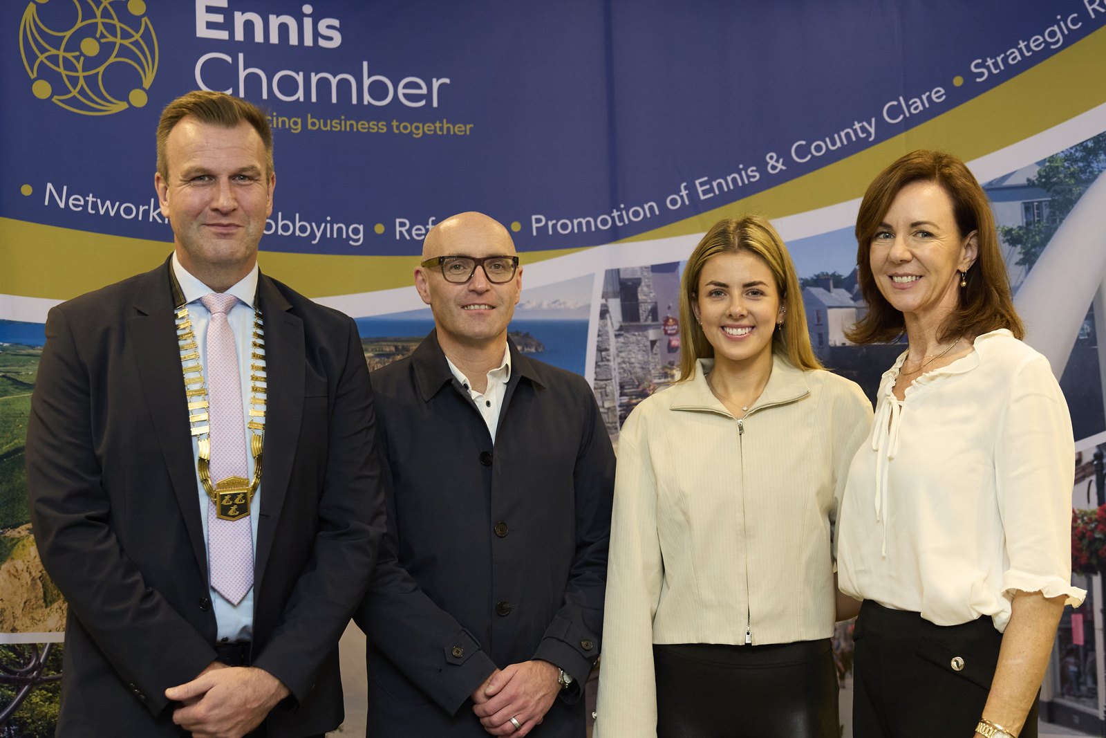 Ennis Chamber President Frank Holly, MHP Sellors Managing Partner Stephen Keogh and Best Family Business finalists Róisín Wynne and Mary Wynne of Route 85 in Inagh, photographed in front of an Ennis Chamber of Commerce banner
